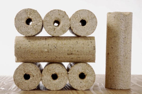 round wooden briquettes isolated against a white background